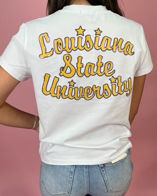 White t-shirt with 'Louisiana State University' printed on the back against a pink background