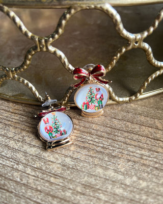 Shop the Christmas Nutcracker Snow Globe Bow Earrings at All About You Boutique! Festive red glitter bows and charming Christmas snow globe designs.