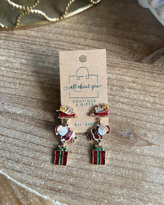 Shop the Christmas Santa Sleigh Earrings at All About You Boutique! Festive glittery Santa, sleigh, and gift dangle earrings perfect for holiday outfits.