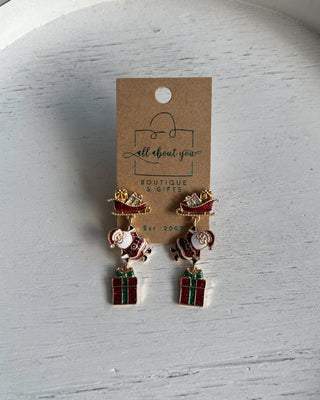 Shop the Christmas Santa Sleigh Earrings at All About You Boutique! Festive glittery Santa, sleigh, and gift dangle earrings perfect for holiday outfits.