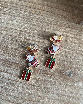 Shop the Christmas Santa Sleigh Earrings at All About You Boutique! Festive glittery Santa, sleigh, and gift dangle earrings perfect for holiday outfits.