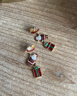 Shop the Christmas Santa Sleigh Earrings at All About You Boutique! Festive glittery Santa, sleigh, and gift dangle earrings perfect for holiday outfits.