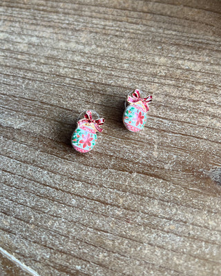 Shop the Christmas Ball Ornament Earrings at All About You Boutique! Festive white ornaments with red glitter bows and floral details. Perfect for holiday outfits.