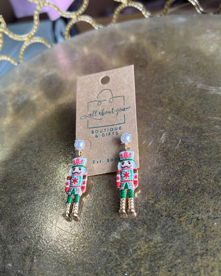 Shop the Nutcracker Pearl Drop Earrings at All About You Boutique! Festive Christmas earrings with faux pearl studs, floral nutcrackers, and gold accents.