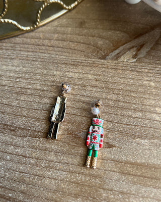 Shop the Nutcracker Pearl Drop Earrings at All About You Boutique! Festive Christmas earrings with faux pearl studs, floral nutcrackers, and gold accents.