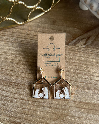 Shop the Nativity Scene Gold Drop Earrings at All About You Boutique! Beautiful gold and white Christmas earrings featuring Mary, Joseph, and baby Jesus.