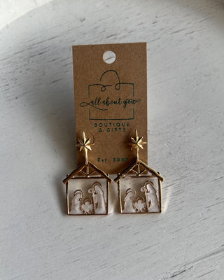 Shop the Nativity Scene Gold Drop Earrings at All About You Boutique! Beautiful gold and white Christmas earrings featuring Mary, Joseph, and baby Jesus.