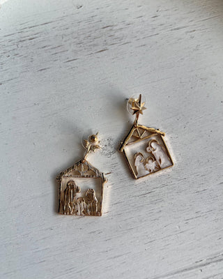 Shop the Nativity Scene Gold Drop Earrings at All About You Boutique! Beautiful gold and white Christmas earrings featuring Mary, Joseph, and baby Jesus.