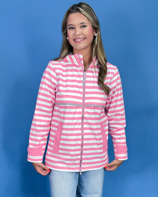 Woman wearing a pink and white striped jacket against a blue background