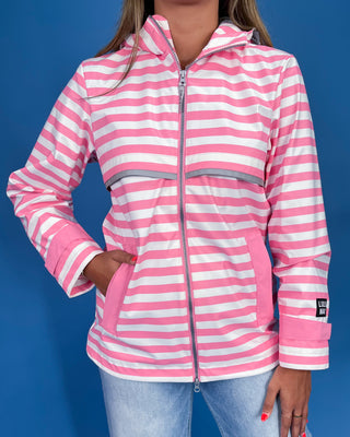 Pink and white striped jacket worn by a person on a blue background