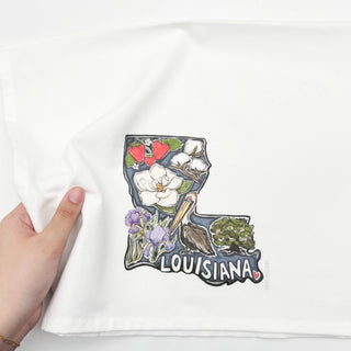 kitchen towel with a colorful 'Louisiana' graphic design held by a hand.