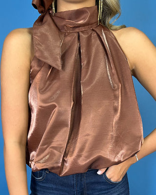 Chocolate satin sleeveless top with a statement tie neckline, pleated front, and chic bubble hem.