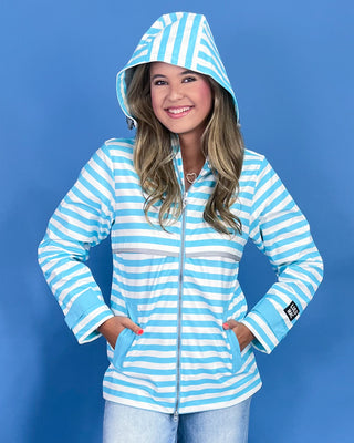 Woman wearing a blue and white striped hoodie against a blue background
