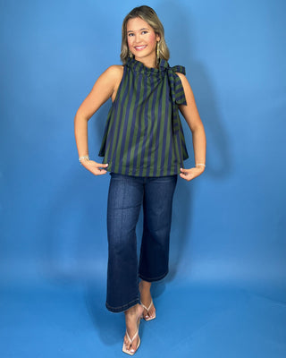 Navy and green striped sleeveless top with a ruffle neckline, statement shoulder tie, and relaxed silhouette.