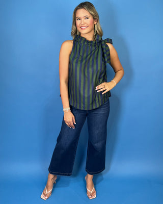Navy and green striped sleeveless top with a ruffle neckline, statement shoulder tie, and relaxed silhouette.