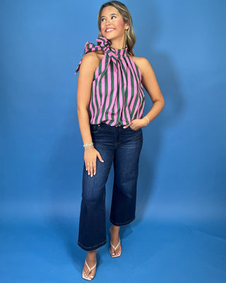 Pink and green striped sleeveless top with a high neckline, statement shoulder bow, and relaxed fit.