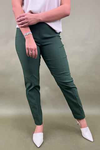 Person wearing green pants and white shoes on a plain background