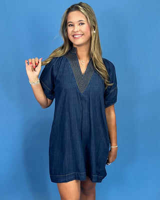 Woman wearing a blue dress against a blue background