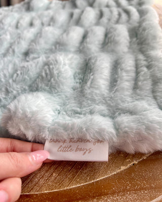 Shop the Bei Bei Faux Fur Lovey in blue, pink, yellow, and ivory. Soft, fluffy baby loveys with sweet messages, perfect for baby showers and newborn gifts.