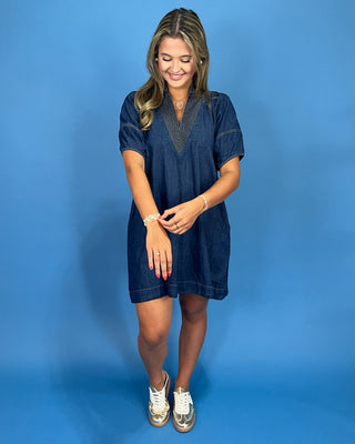 Woman wearing a blue dress against a blue background