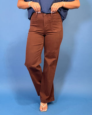 Chocolate brown high-rise wide leg jeans with front patch pockets, a flattering structured fit, and full-length silhouette.