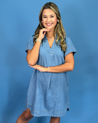 Woman wearing a blue dress against a blue background