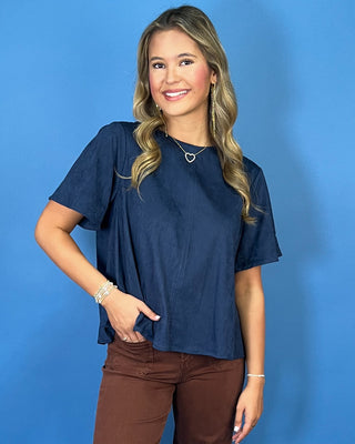 Navy blue short sleeve top with a soft suede-like texture, round neckline, relaxed fit, and easy everyday silhouette.