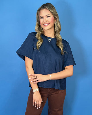 Navy blue short sleeve top with a soft suede-like texture, round neckline, relaxed fit, and easy everyday silhouette.