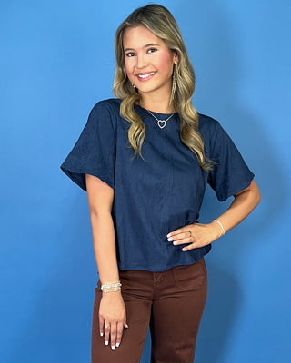Navy blue short sleeve top with a soft suede-like texture, round neckline, relaxed fit, and easy everyday silhouette.