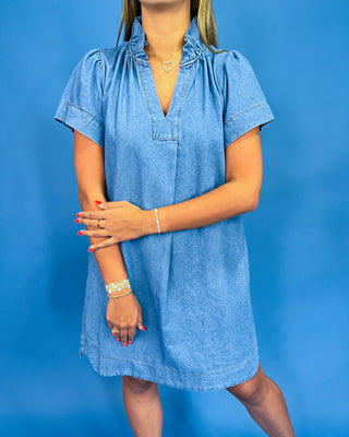 Woman wearing a blue dress against a blue background