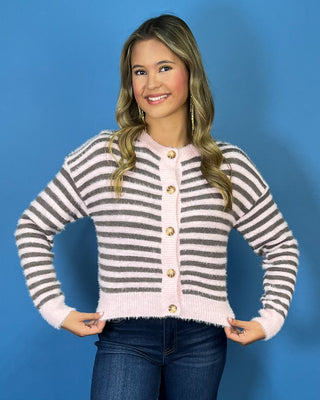 Soft pink and charcoal striped fuzzy knit cardigan with a button-front design, round neckline, and contrast pink trim.