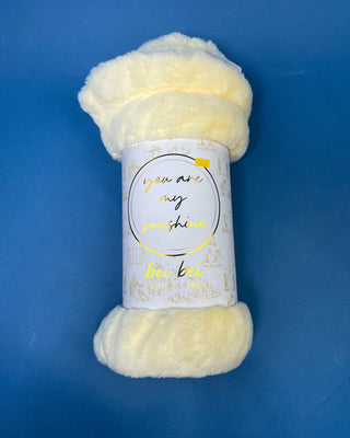 Shop the Bei Bei Faux Fur Petite Blanket in pink, blue, yellow, and white. A soft, fluffy baby blanket perfect for newborn gifts and baby showers.