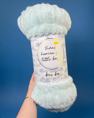 Shop the Bei Bei Faux Fur Petite Blanket in pink, blue, yellow, and white. A soft, fluffy baby blanket perfect for newborn gifts and baby showers.
