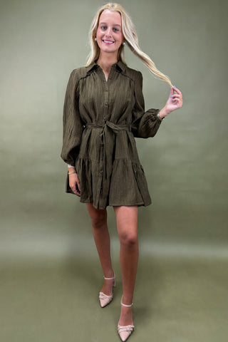 Woman wearing a green dress against a green background