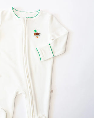 White baby onesie with green trim and duck design on a white background