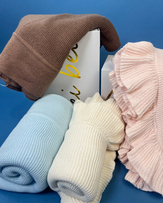 Shop the Ruffle Knit Baby Blanket in Petal Pink & Cloud White. Features soft textured knit and delicate double-layered ruffles. Perfect for baby gifts.