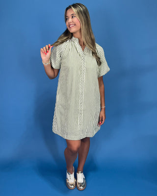 Woman wearing a striped dress against a blue background