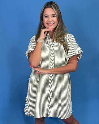 Woman wearing a striped dress against a blue background