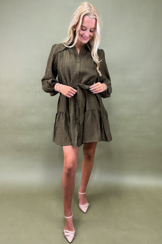 Woman wearing a green dress against a matching background