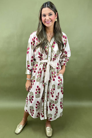 Woman wearing a floral dress against a green background