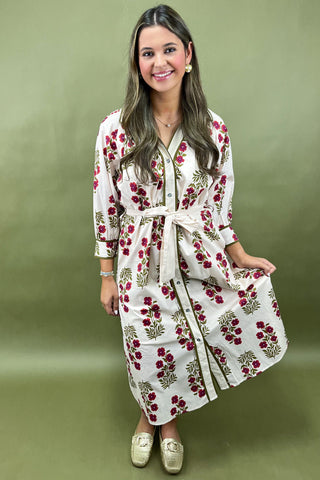 Woman wearing a floral dress against a green background