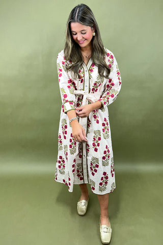 Woman wearing a floral dress against a green background