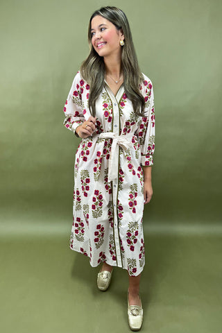 Woman wearing a floral dress against a green background
