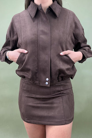 Brown jacket and skirt set on a plain background