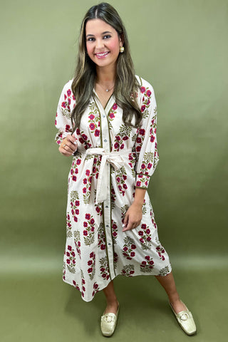 Woman wearing a floral dress on a green background