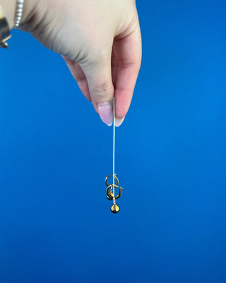 Shop the Enewton Huggie Hoop Gold Charm Earrings featuring polished gold hoops and dangling gold ball charms for timeless everyday style.