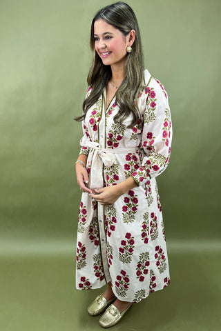 Woman wearing a floral dress on a green background
