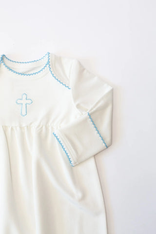 White dress with blue embroidery on a white background