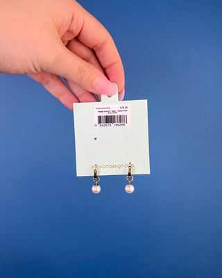 Shop the Enewton Huggie Hoop Pearl Charm Earrings featuring polished gold hoops and elegant dangling white pearl charms for timeless everyday style.