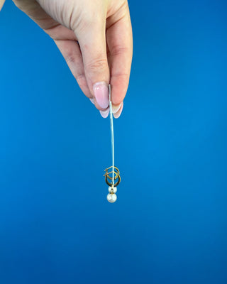 Shop the Enewton Huggie Hoop Pearl Charm Earrings featuring polished gold hoops and elegant dangling white pearl charms for timeless everyday style.
